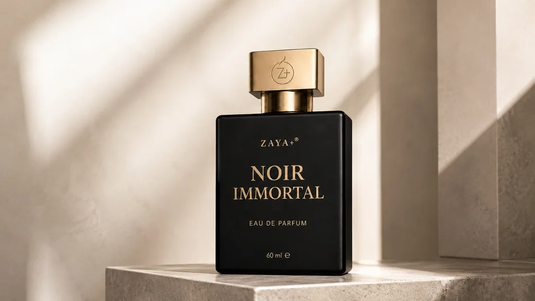 The Noir Immortal flacon standing on a pale stone plinth in soft daylight against an ivory wall